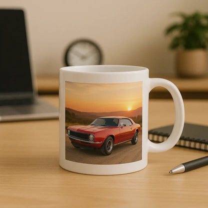White mug with custom red classic car print, placed on office desk with pen and notebook