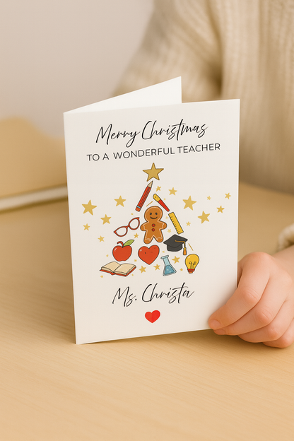 Personalised Christmas card for teacher with festive tree and school-themed icons, held by hand