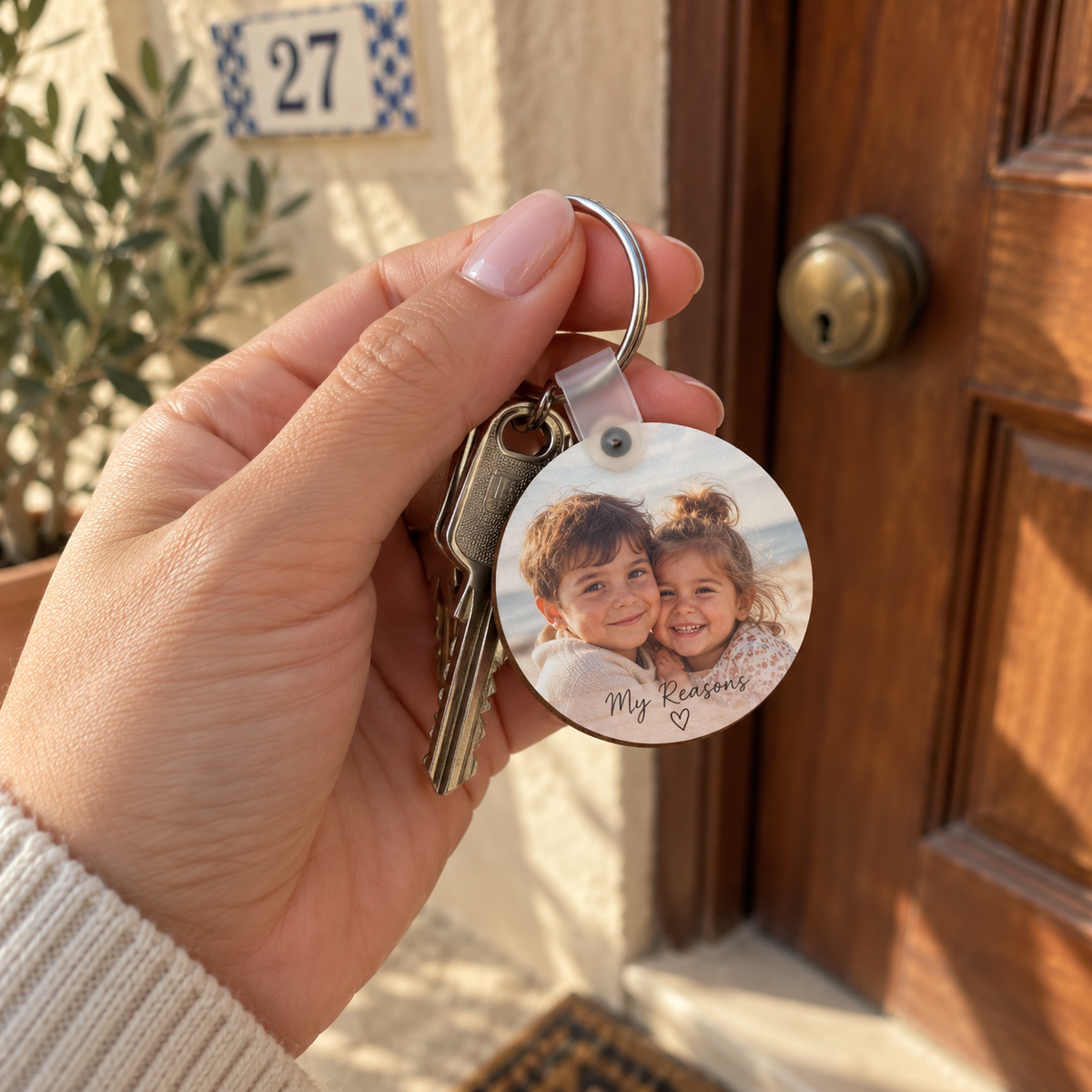 Personalised family photo keychain held with house keys