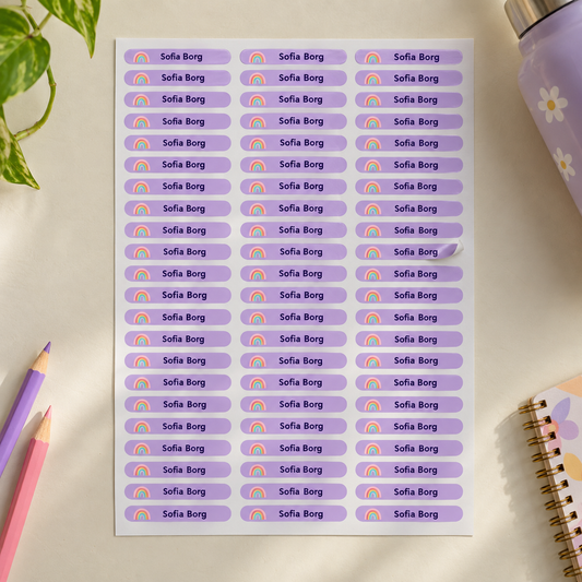 Full sheet of lilac personalised school name stickers with rainbow icon