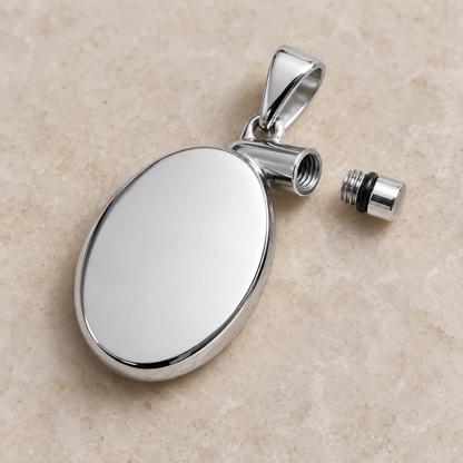 Silver oval pet keepsake pendant with screw-sealed capsule for hair or ashes, shown open